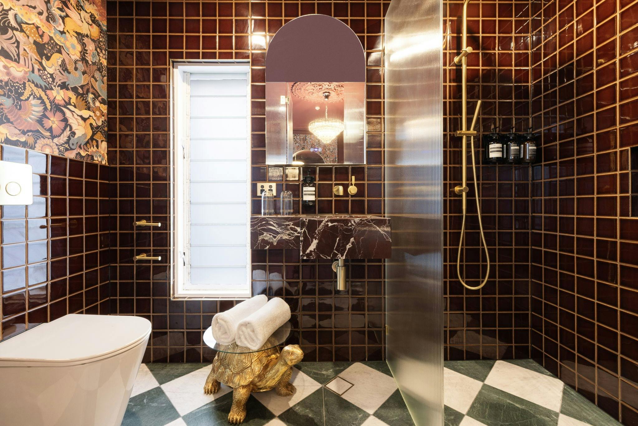 The grand velvet suite bathroom is rich in colour, style and pattern.  Luxury bathroom amenities.