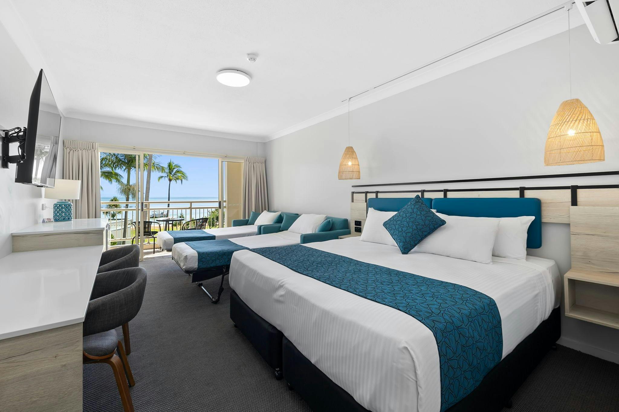 Hotel room with king bed, pull out singles and ocean view