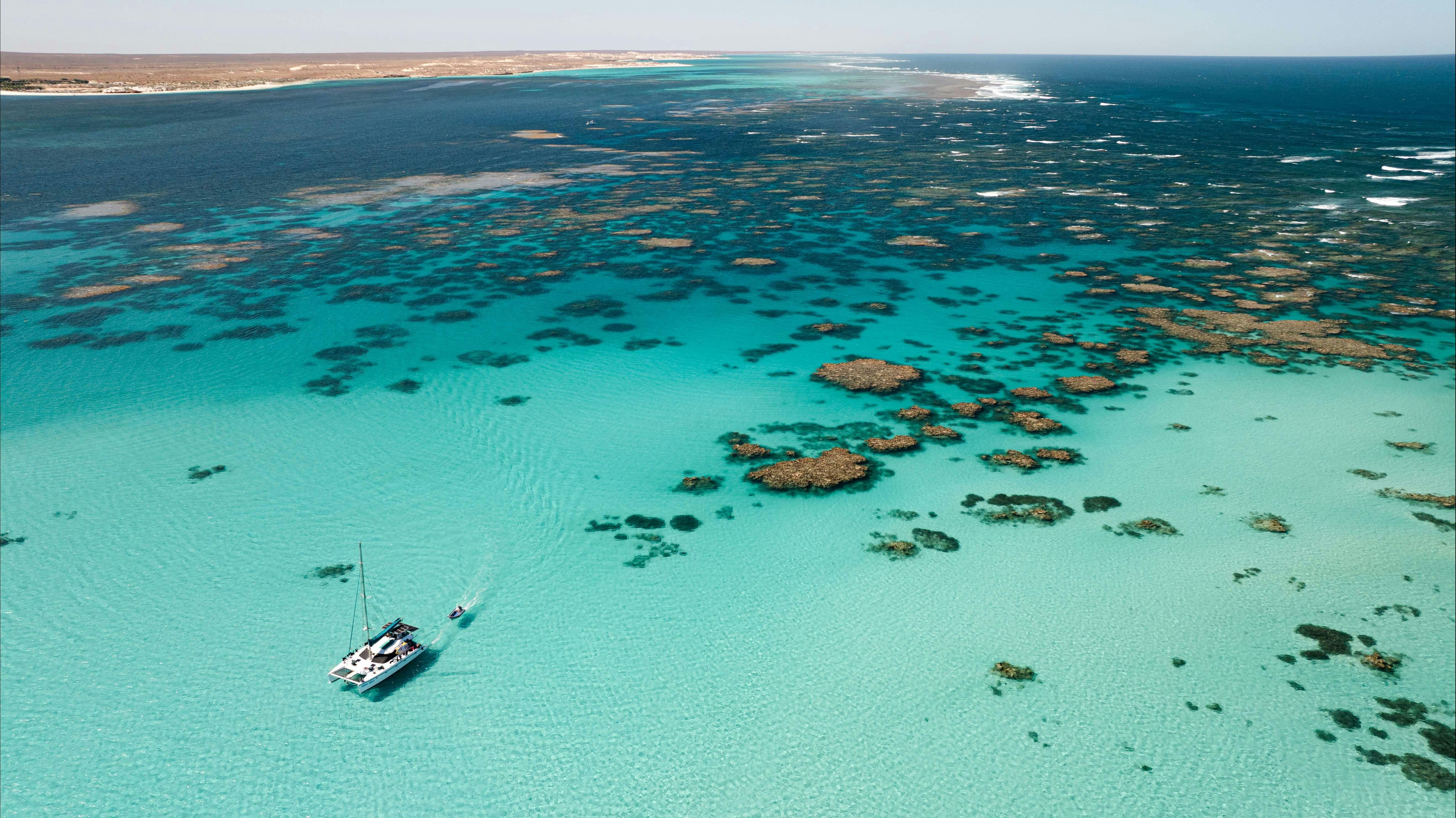 Aerial view of vessel Shore Thing amongst the Ningaloo reef fringe