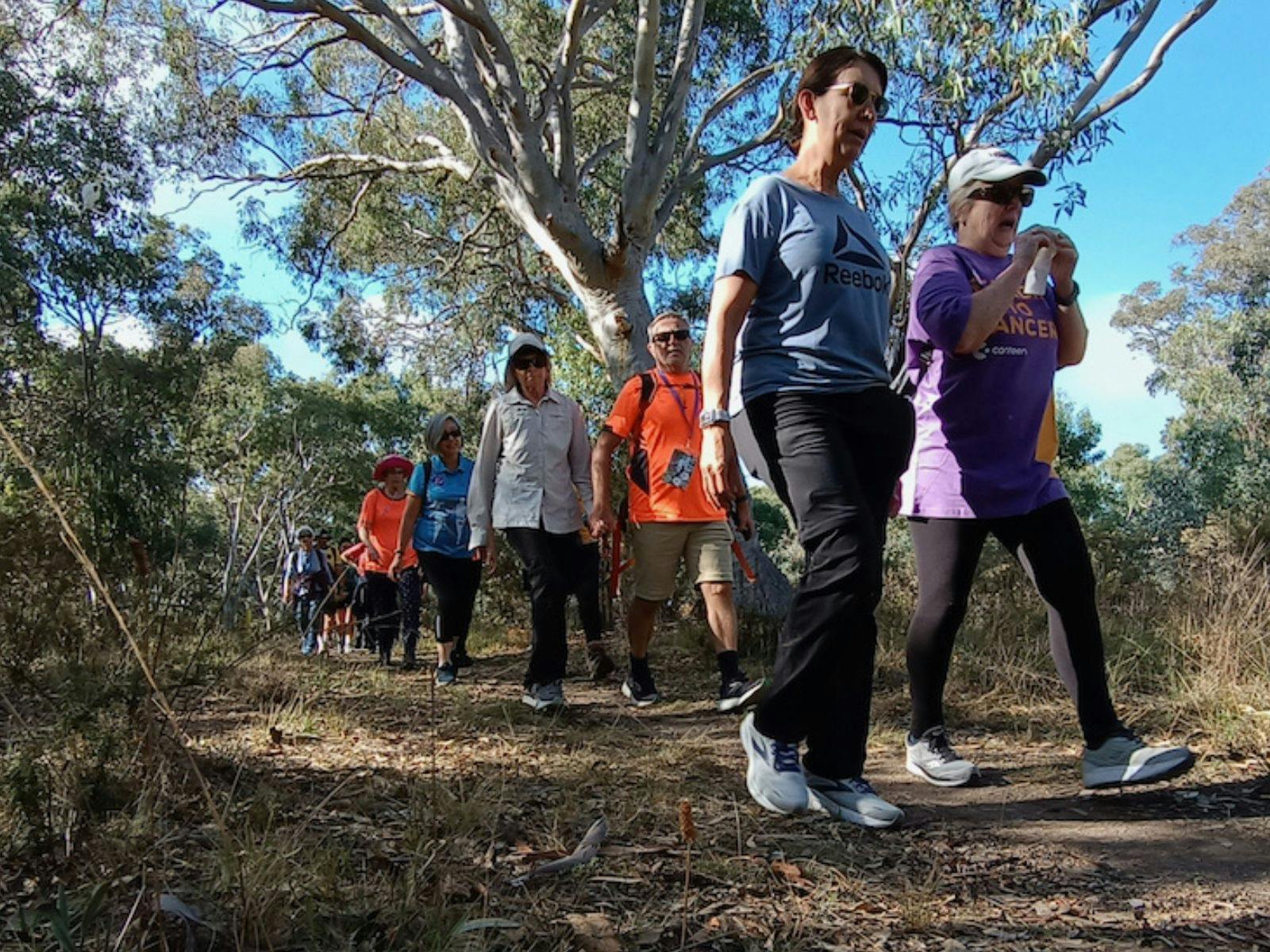 a group of people walking through the bush