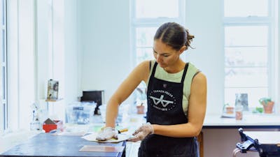 A woman prepares an etching using inks and paper