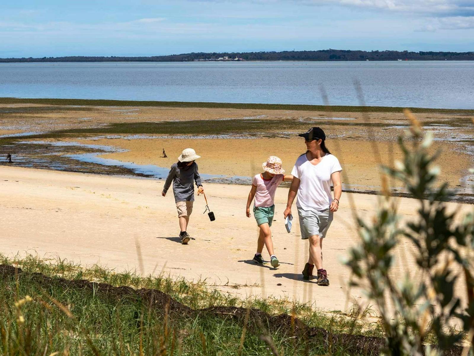 Family walking along French Island Beach