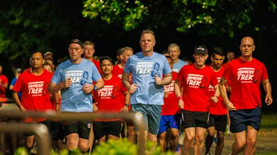 Group of people running in Dusk till Dawn tshirts