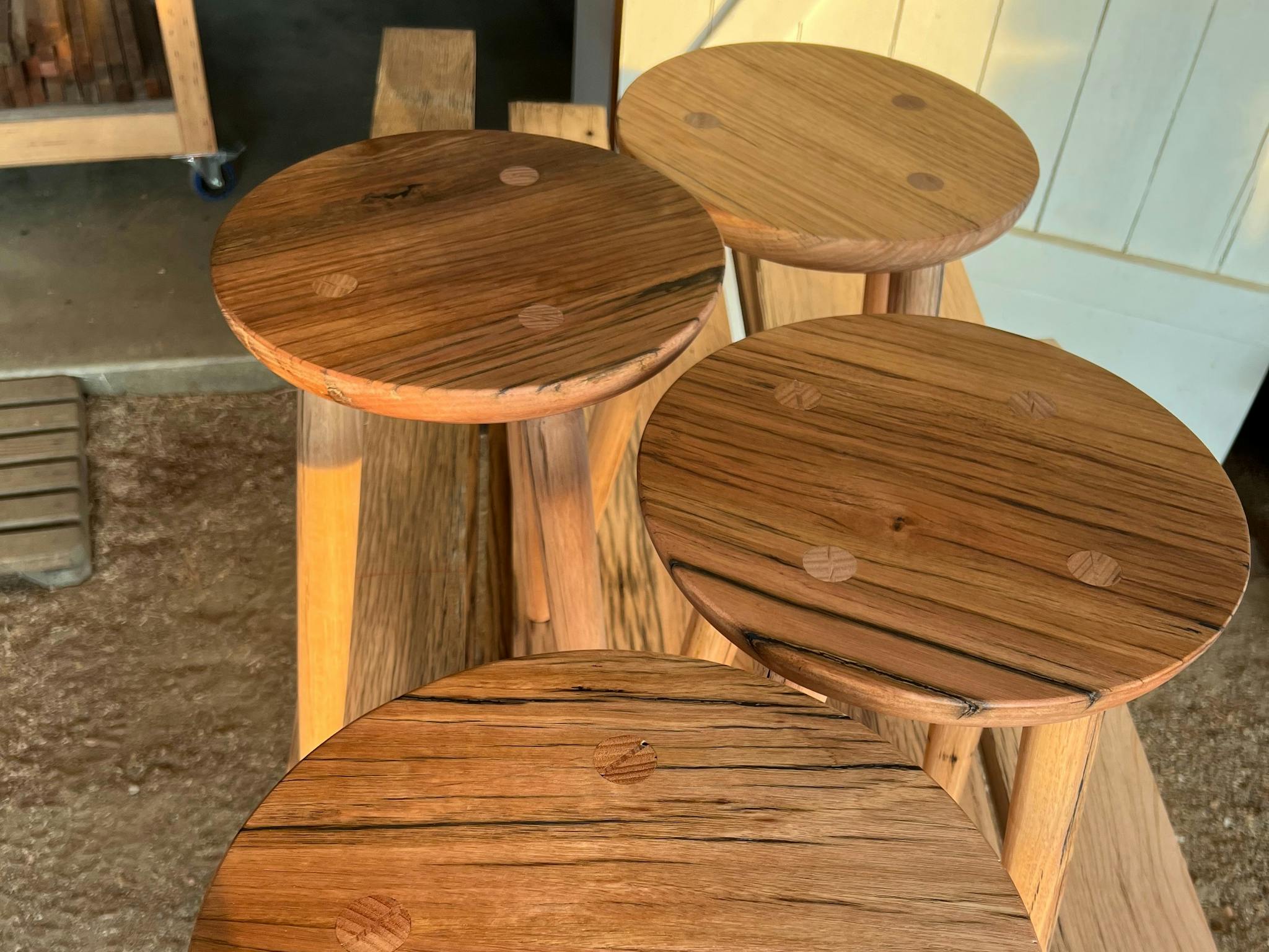 Three tops of recycled timber stools.