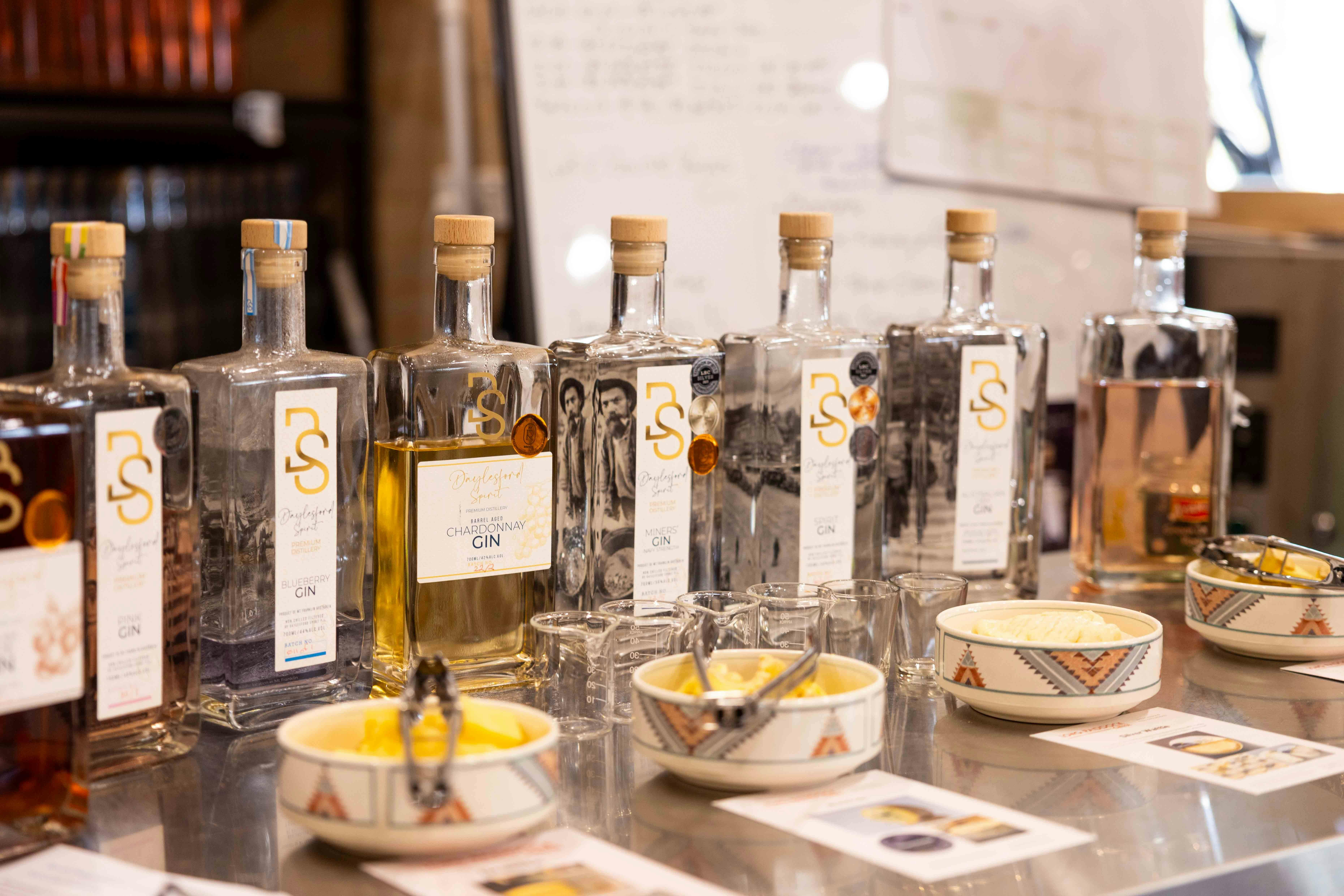 A row of gin bottles and Long Paddock cheese ready for tasting