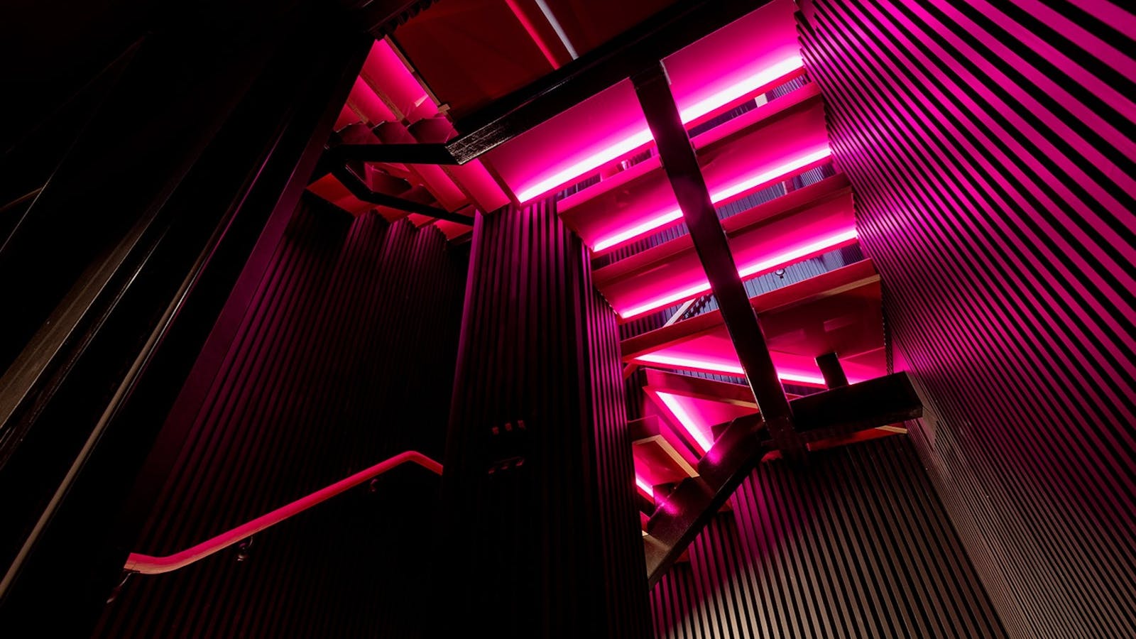 rchitectural staircase with dramatic lighting and industrial-inspired design.