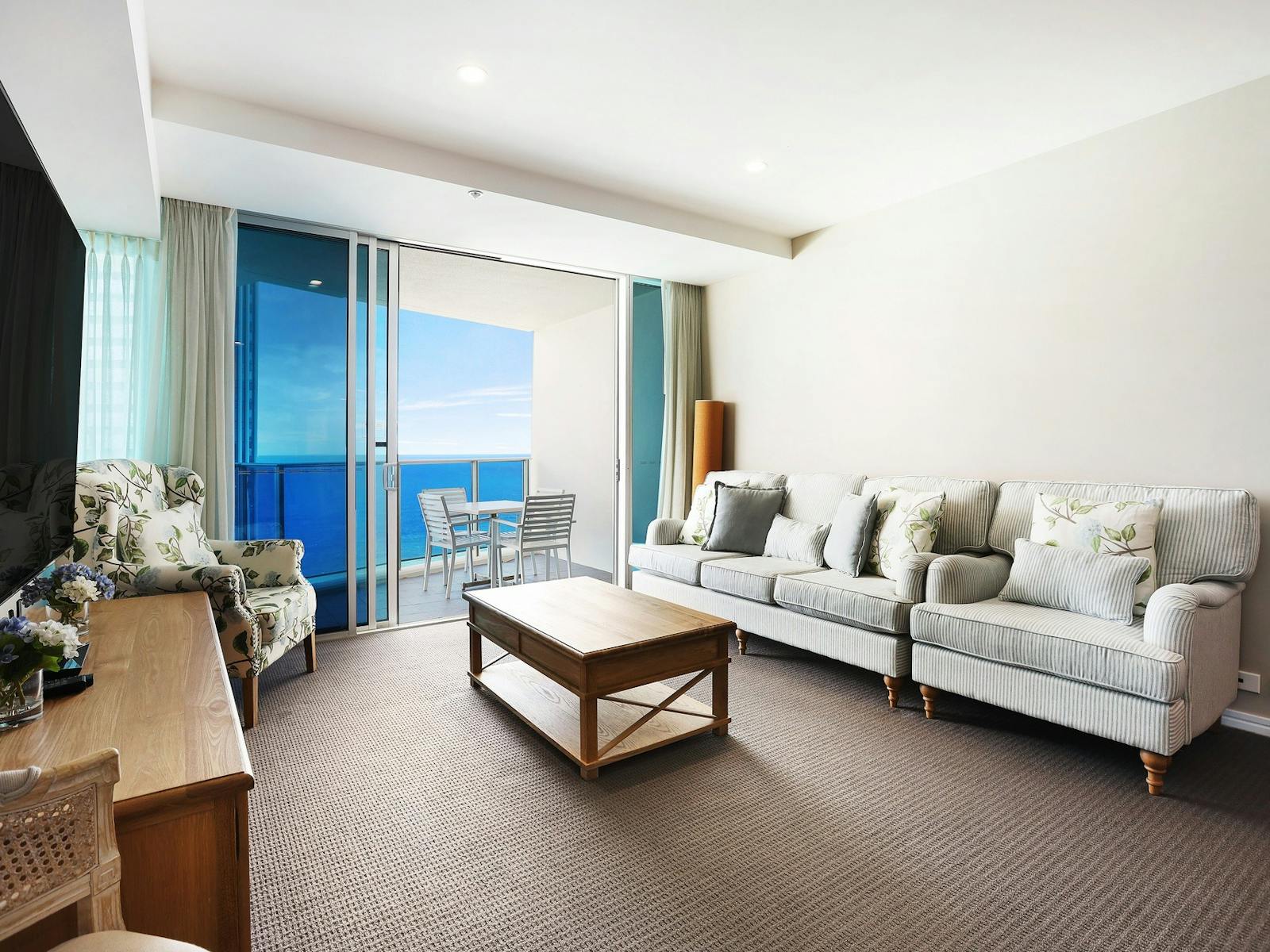 Lounge room with huge tv, balcony ocean views - Hilton Residences Surfers Paradise Lounge room with huge tv, balcony ocean views - Hilton Residences Surfers Paradise