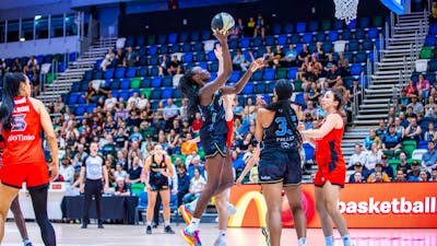 UC Capitals player driving to the basket for a layup during a WNBL game against Perth Lynx.