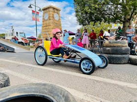 Young girl participating in the Better In Blackall billy cart races