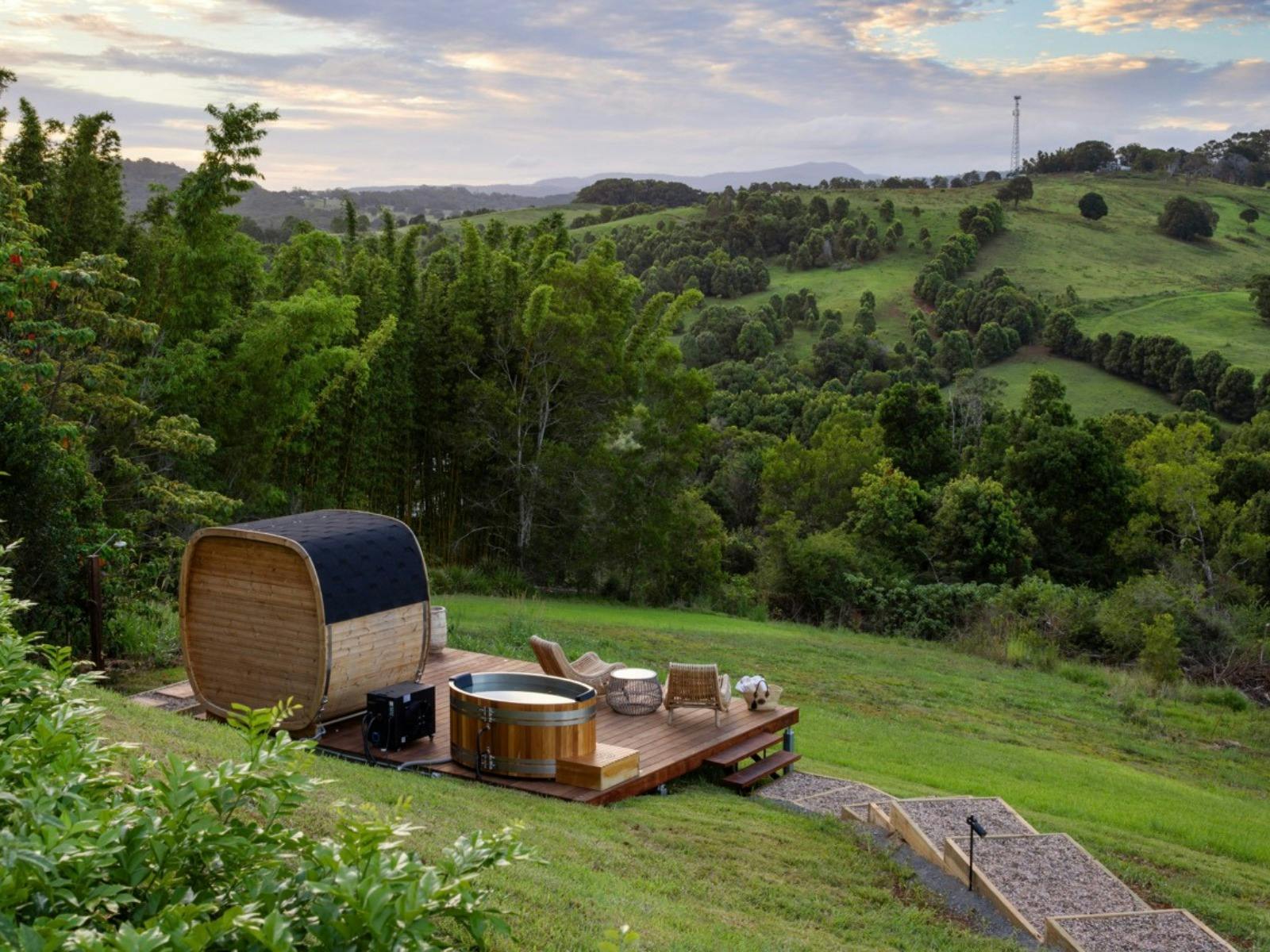 Private cedar sauna and ice bath on an elevated timber deck overlooking rolling hinterland valleys a