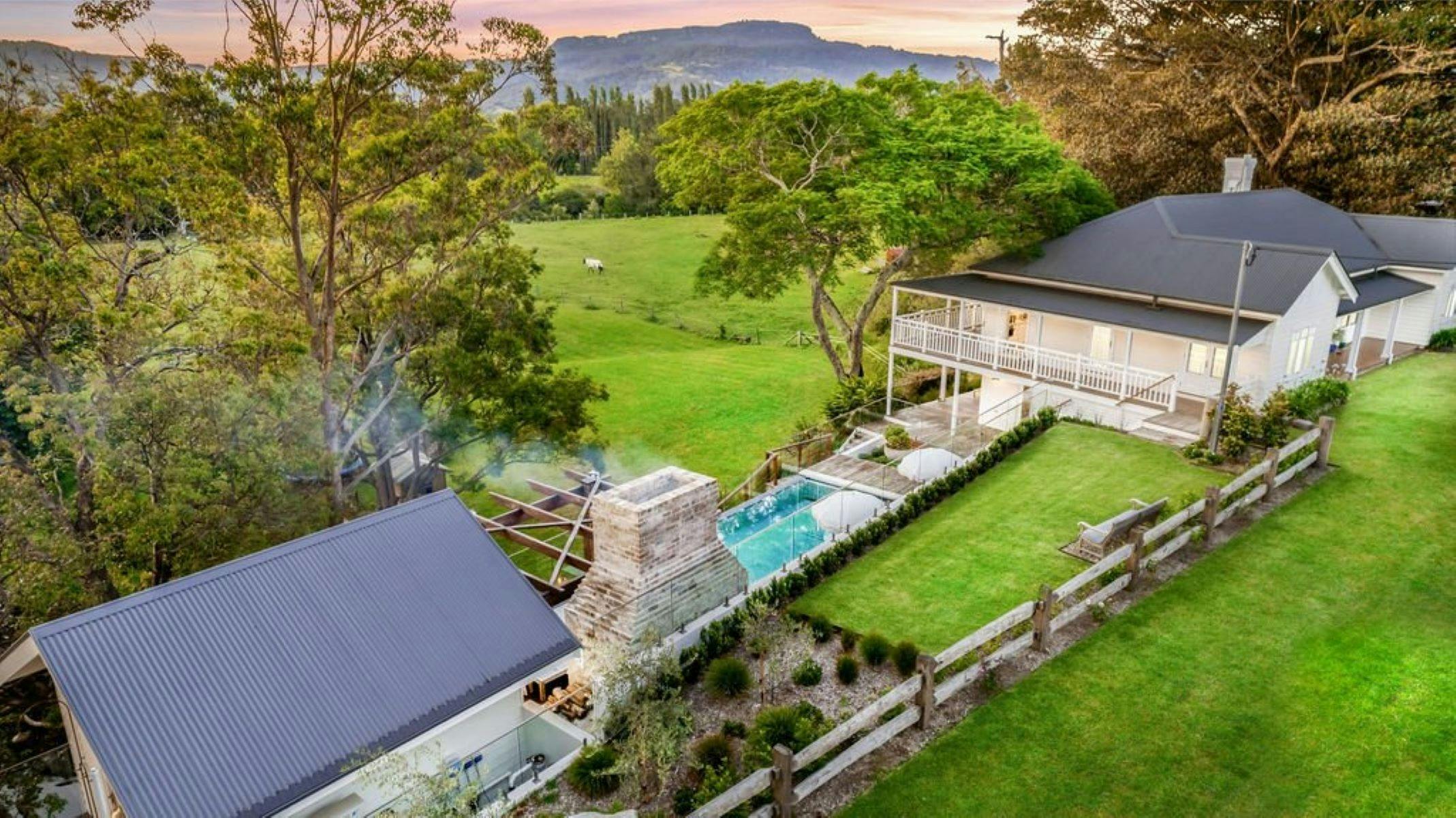 Image of aerial view of property. You can see pool and two buildings sit either side of the pool