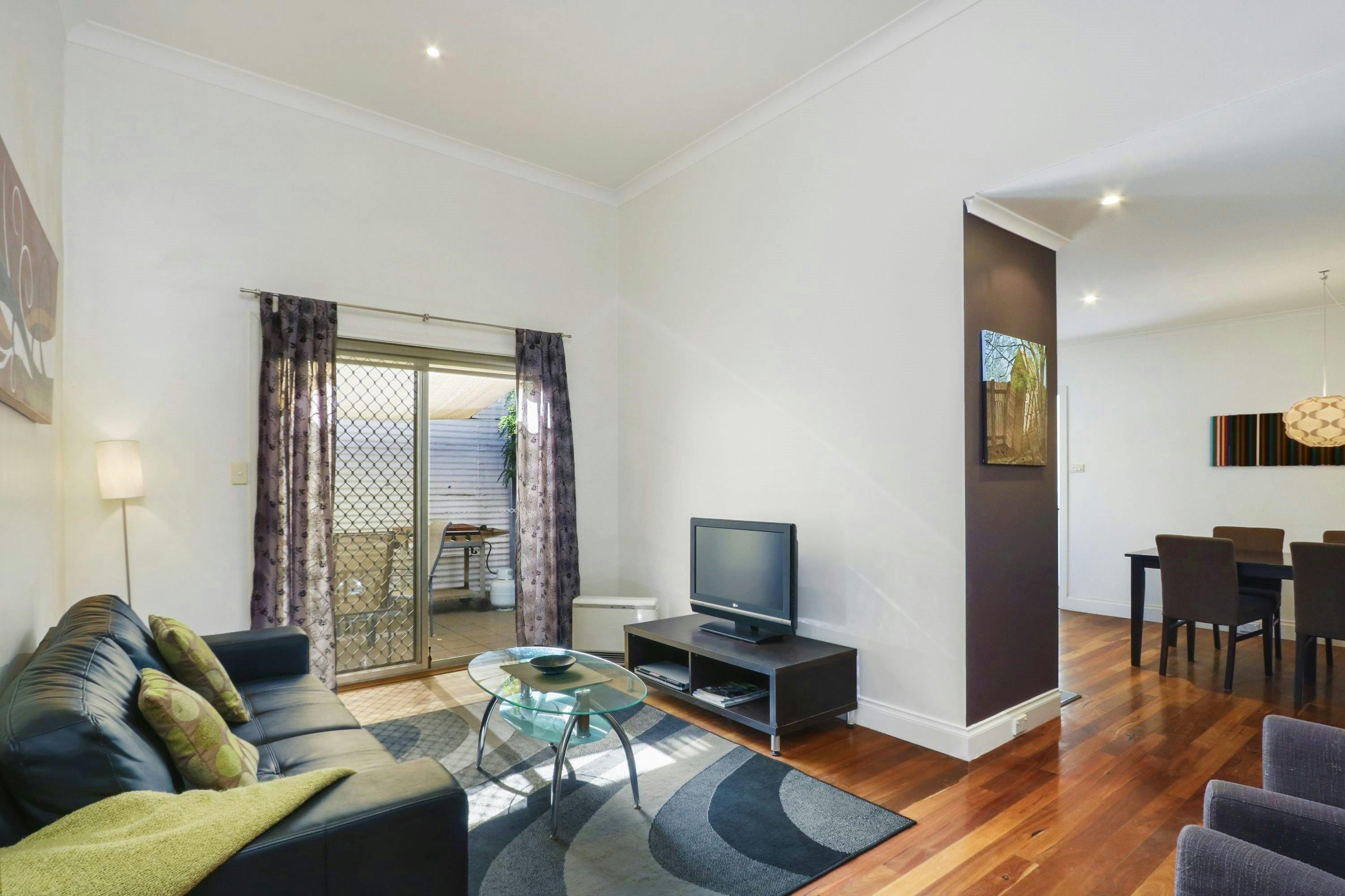 Comfortable lounge-room with sliding doors to the private courtyard