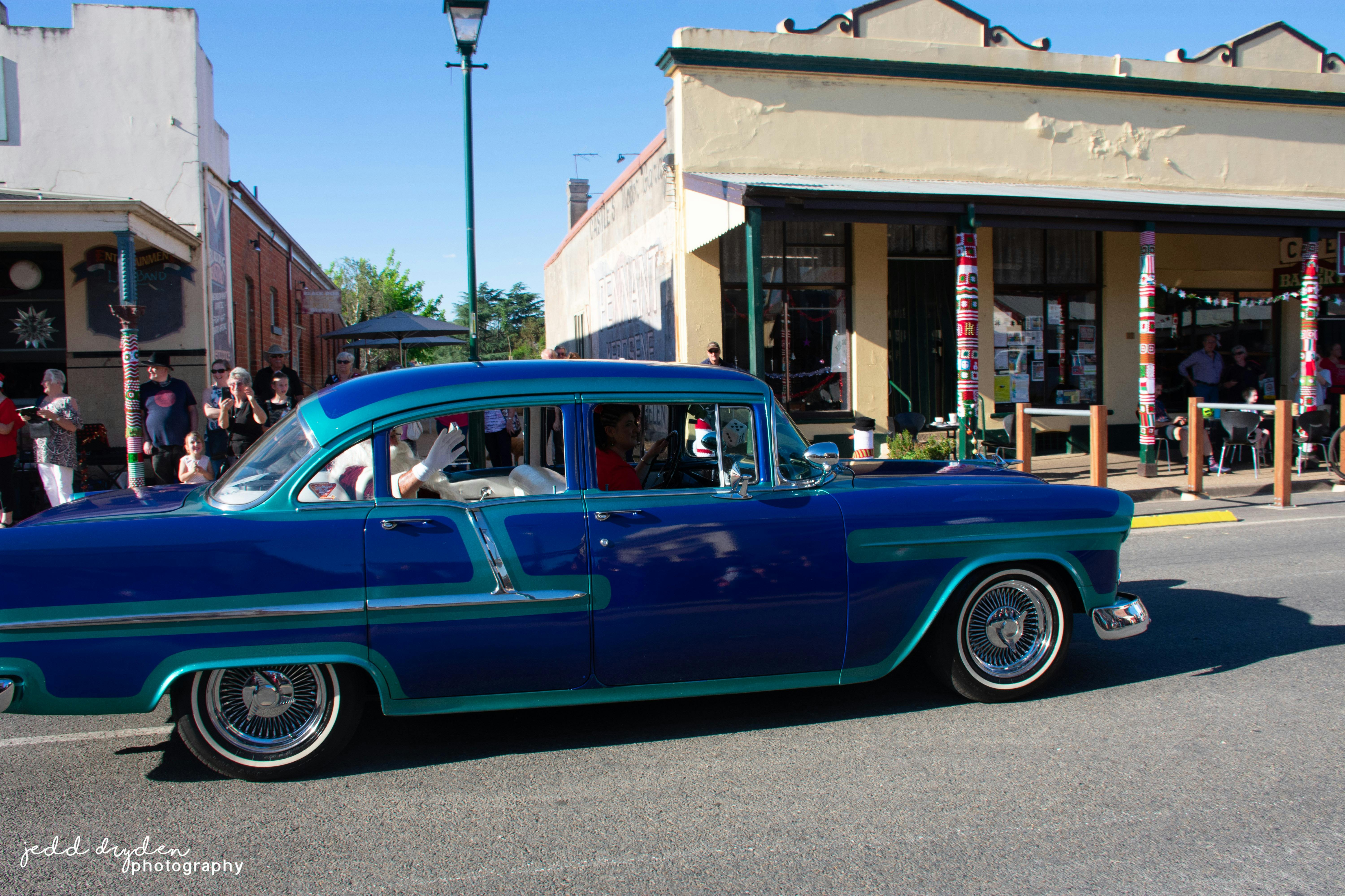 Father Christmas arriving in parade in vintage car