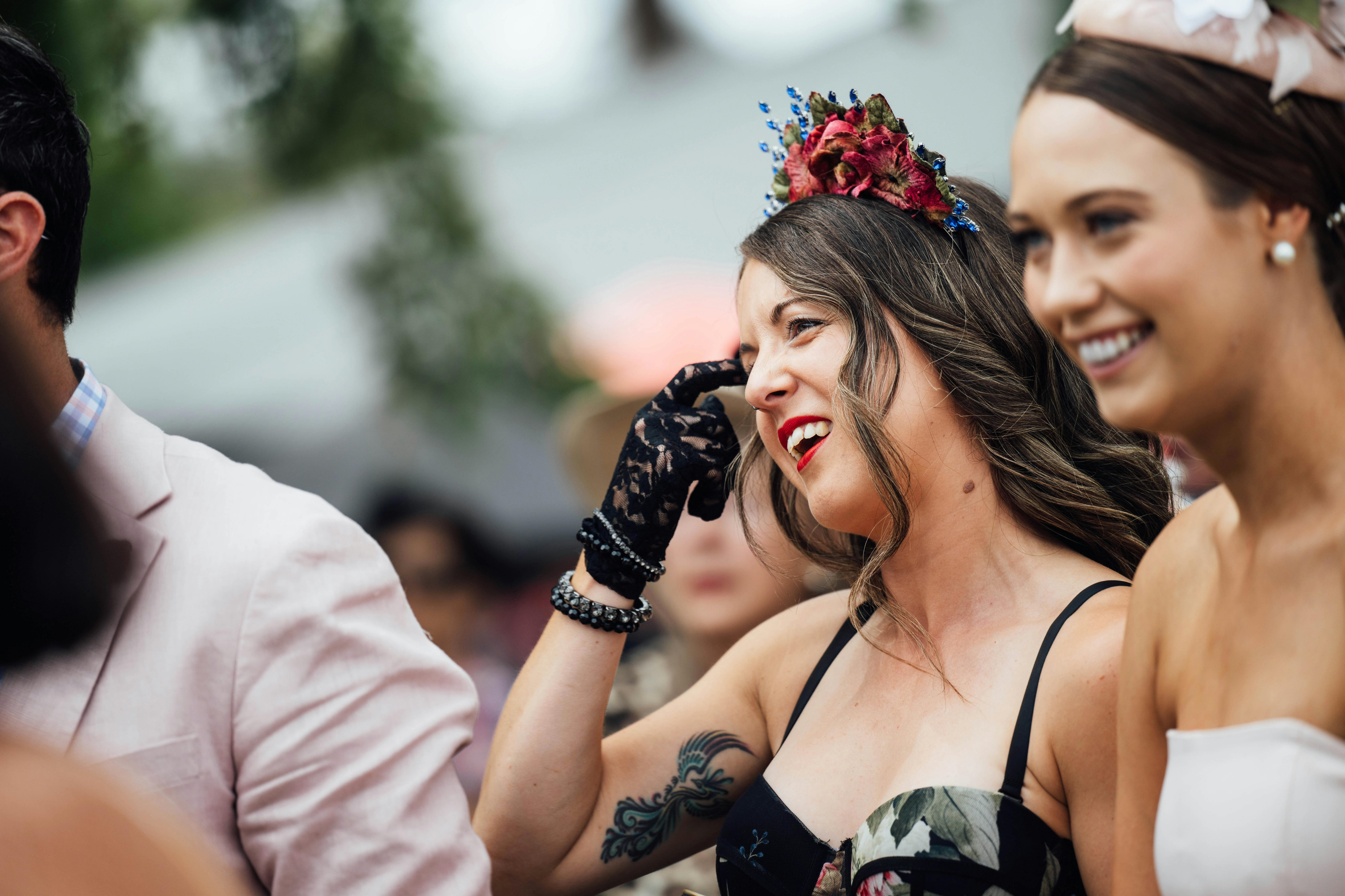 Women dressed in cup wear, watching an event