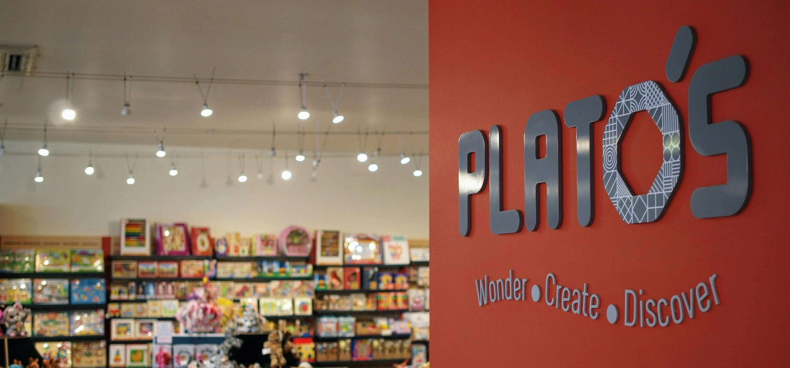 Plato's Logo with Shop in Background