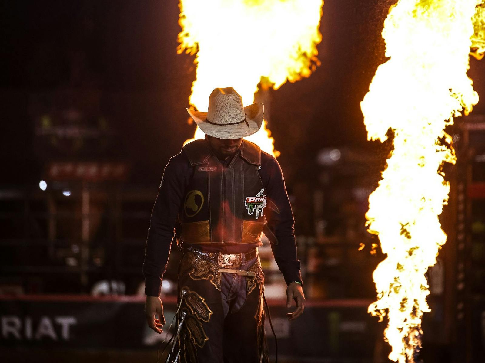 PBR cowboy walking into arena PBR cowboy walking into arena