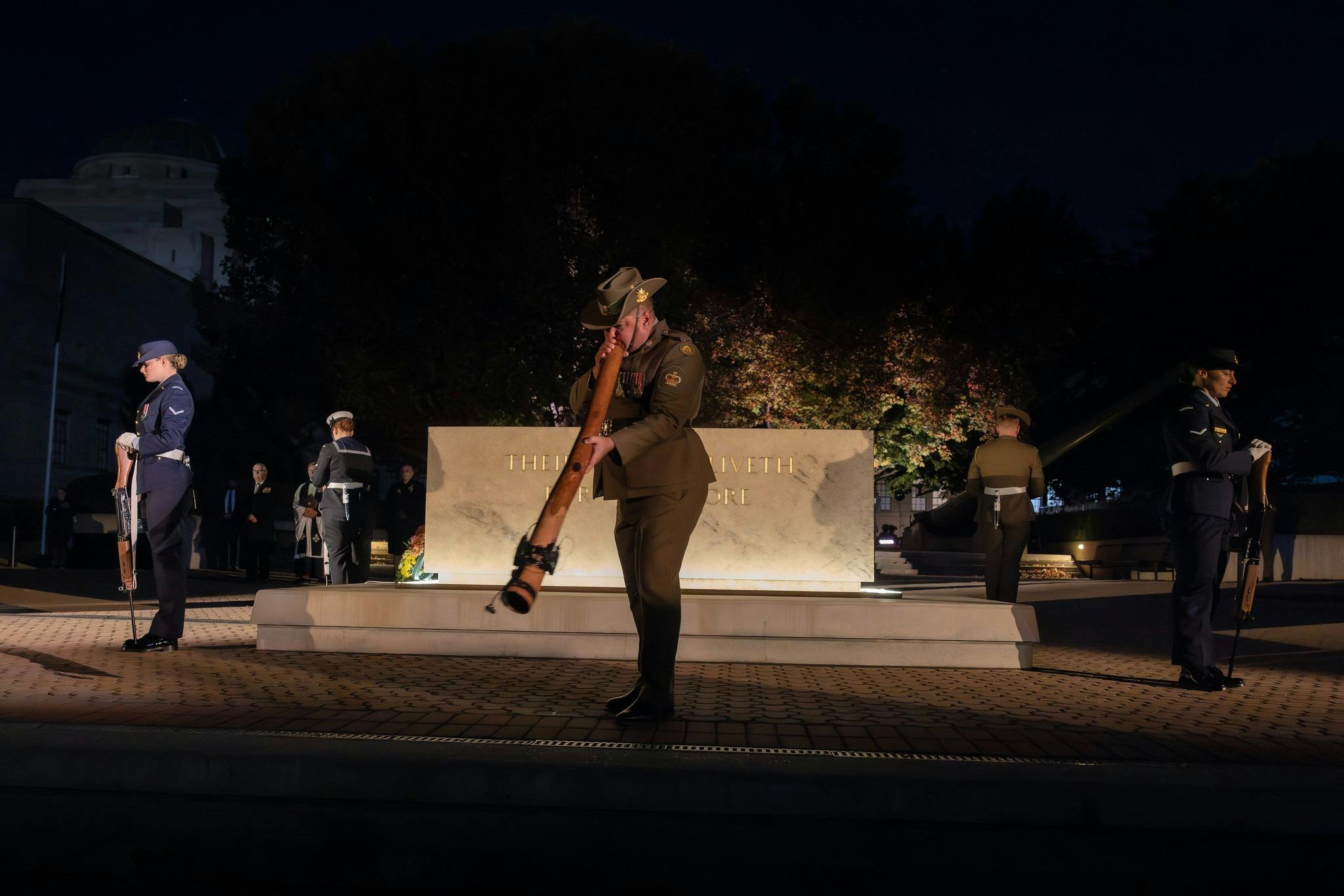Didgeridoo player and catafalque party at the Australian War Memorial Anzac Day Dawn Service
