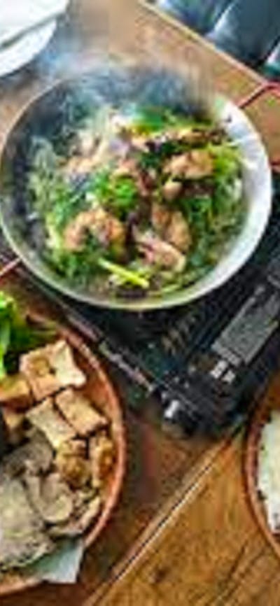 Asian dishes steaming laid out on a table