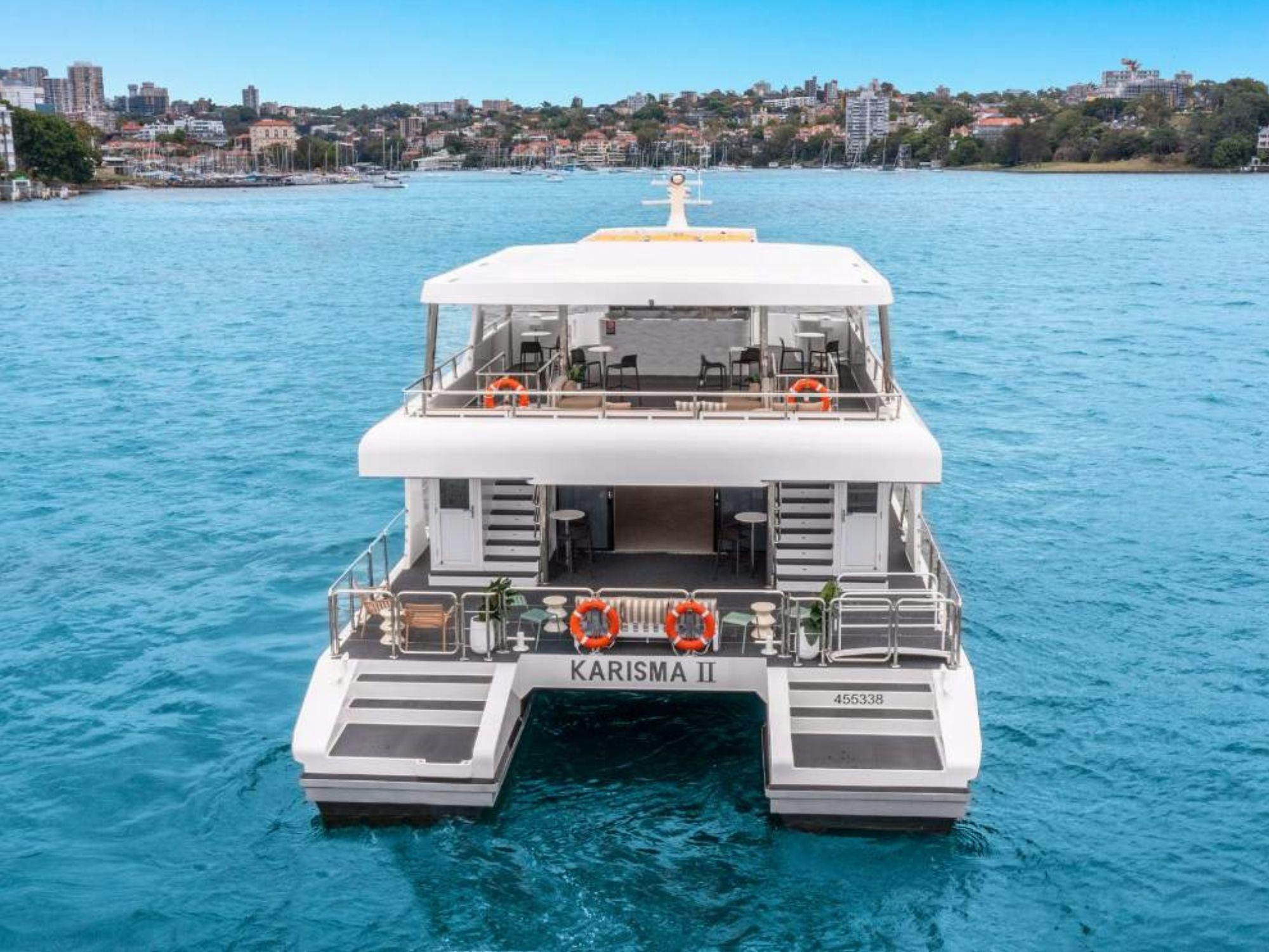 Rear view of the Karisma 2 catamaran on Sydney Harbour, showing its dual-level decks
