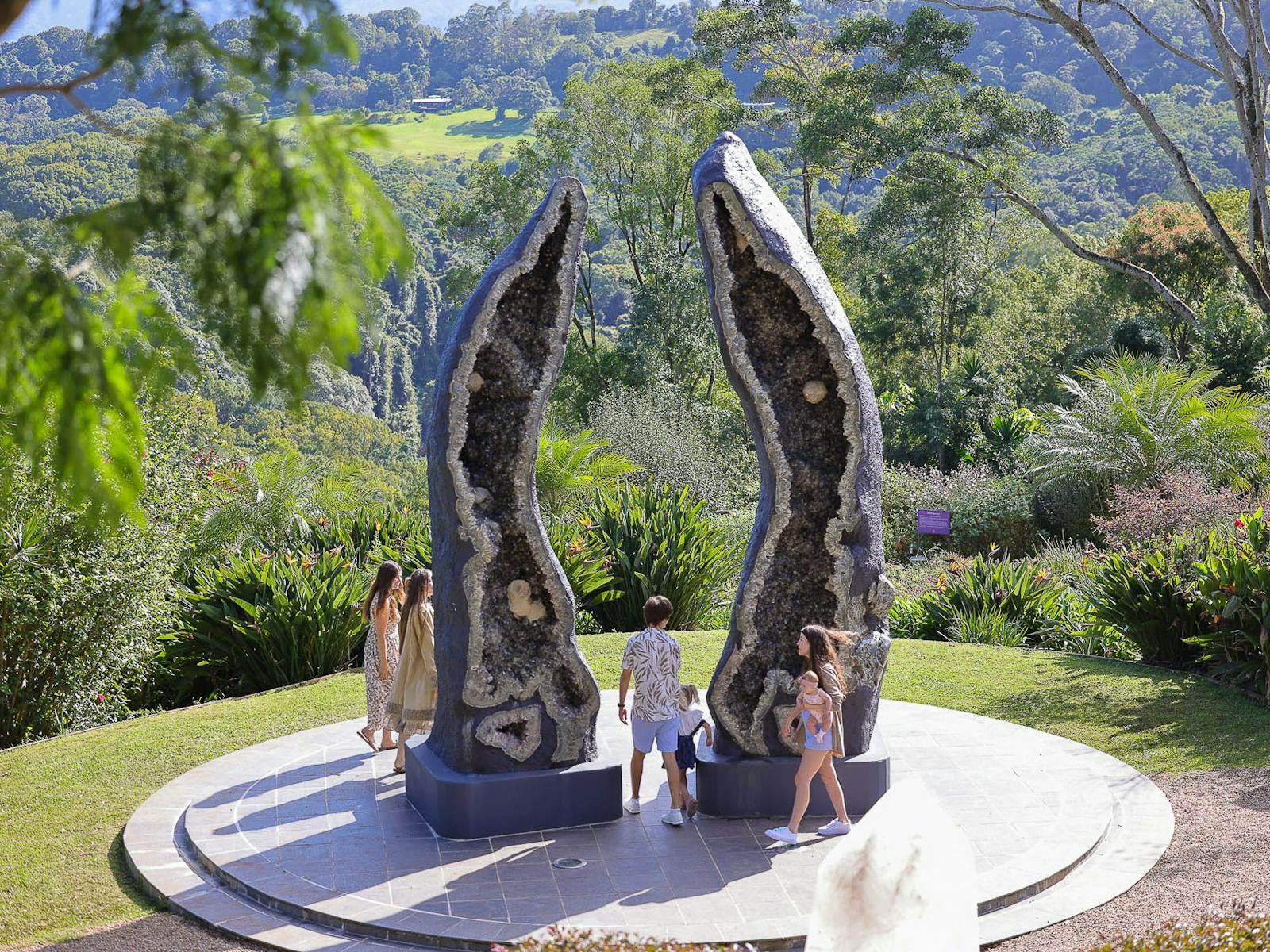 A group of friends admiring the Crystal Guardians, worlds-largest amethyst and smoky quartz geodes