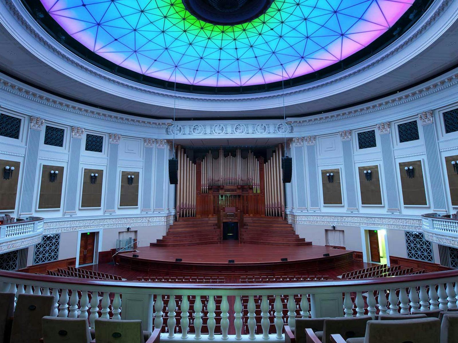 A large organ in a grand auditorium.