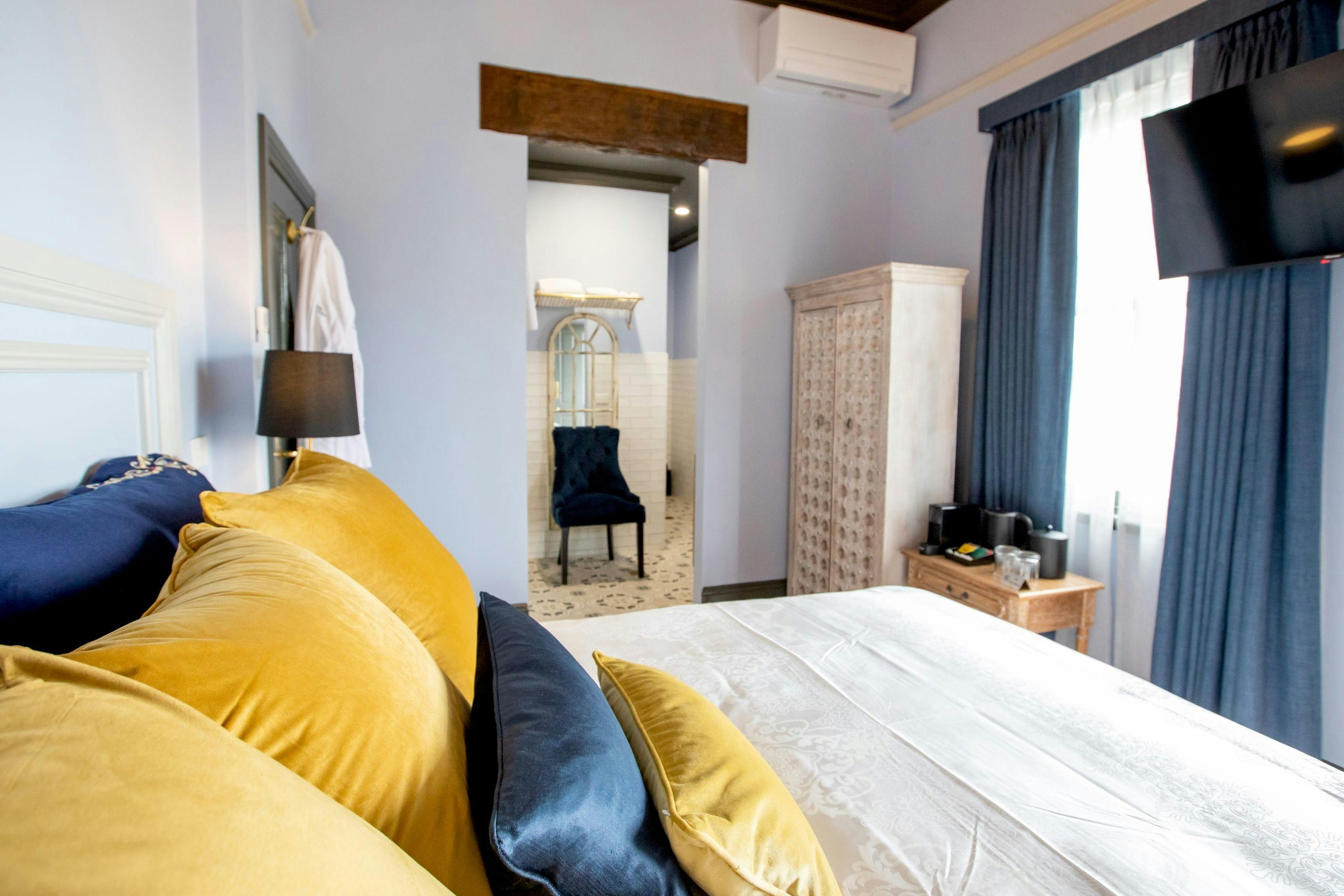 Bed looking into bathroom