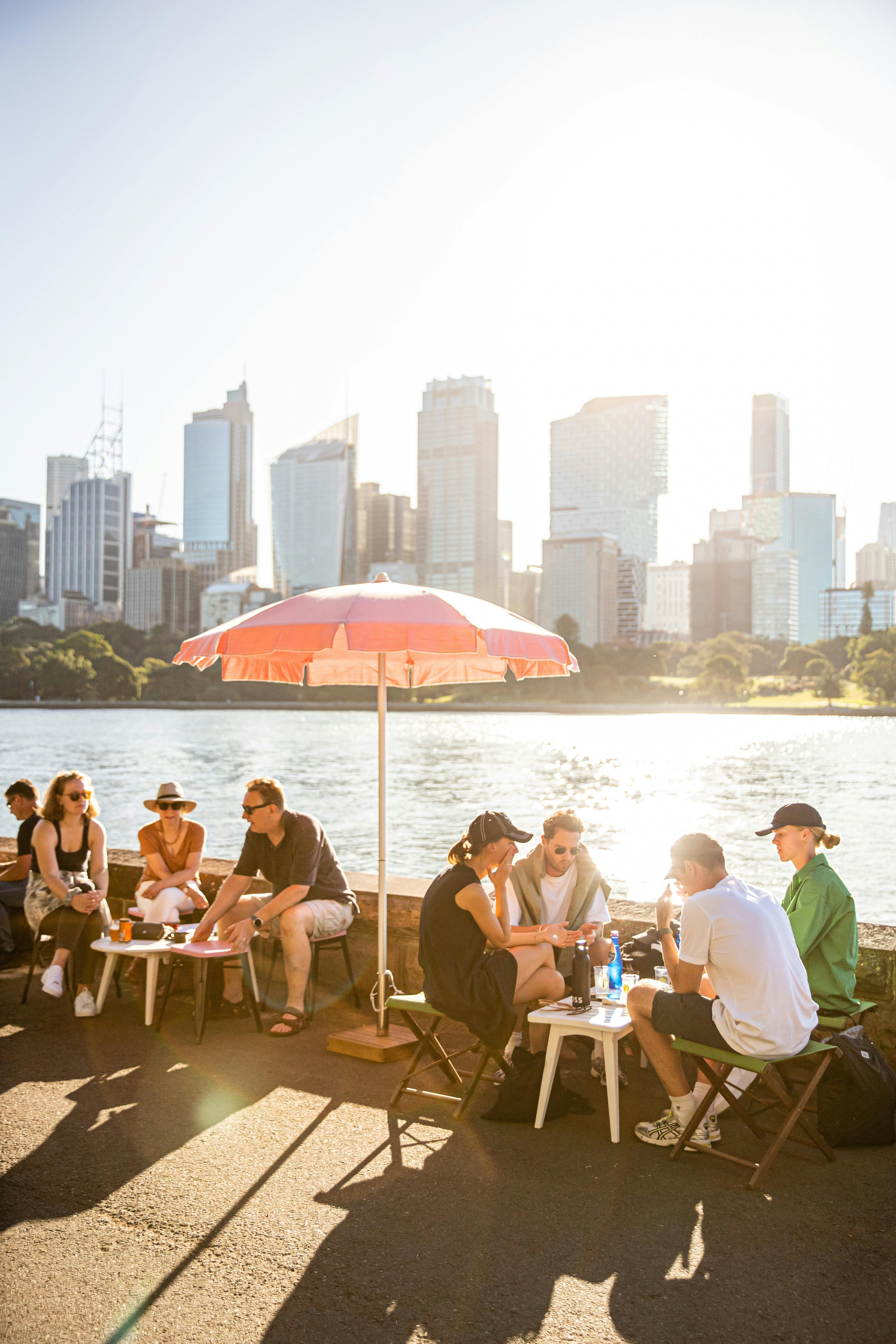 friends enjoying drinks at a harbourside table