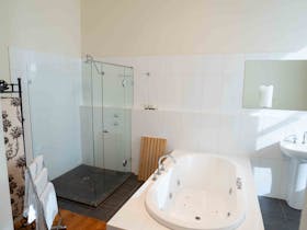 Spa bath, large free-standing shower, toilet and basin