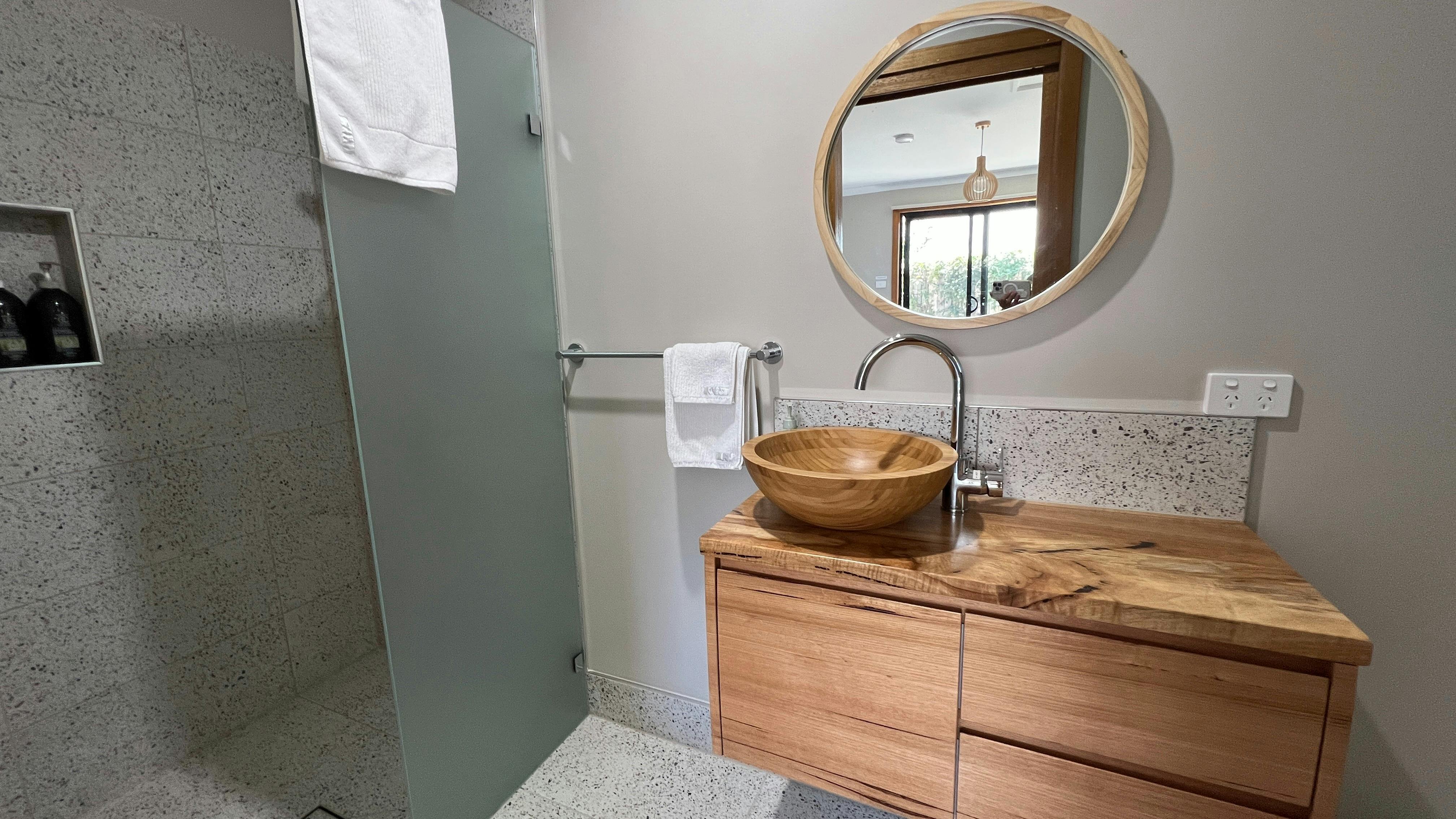 Shower, bamboo basin, mirror, vanity cabinet
