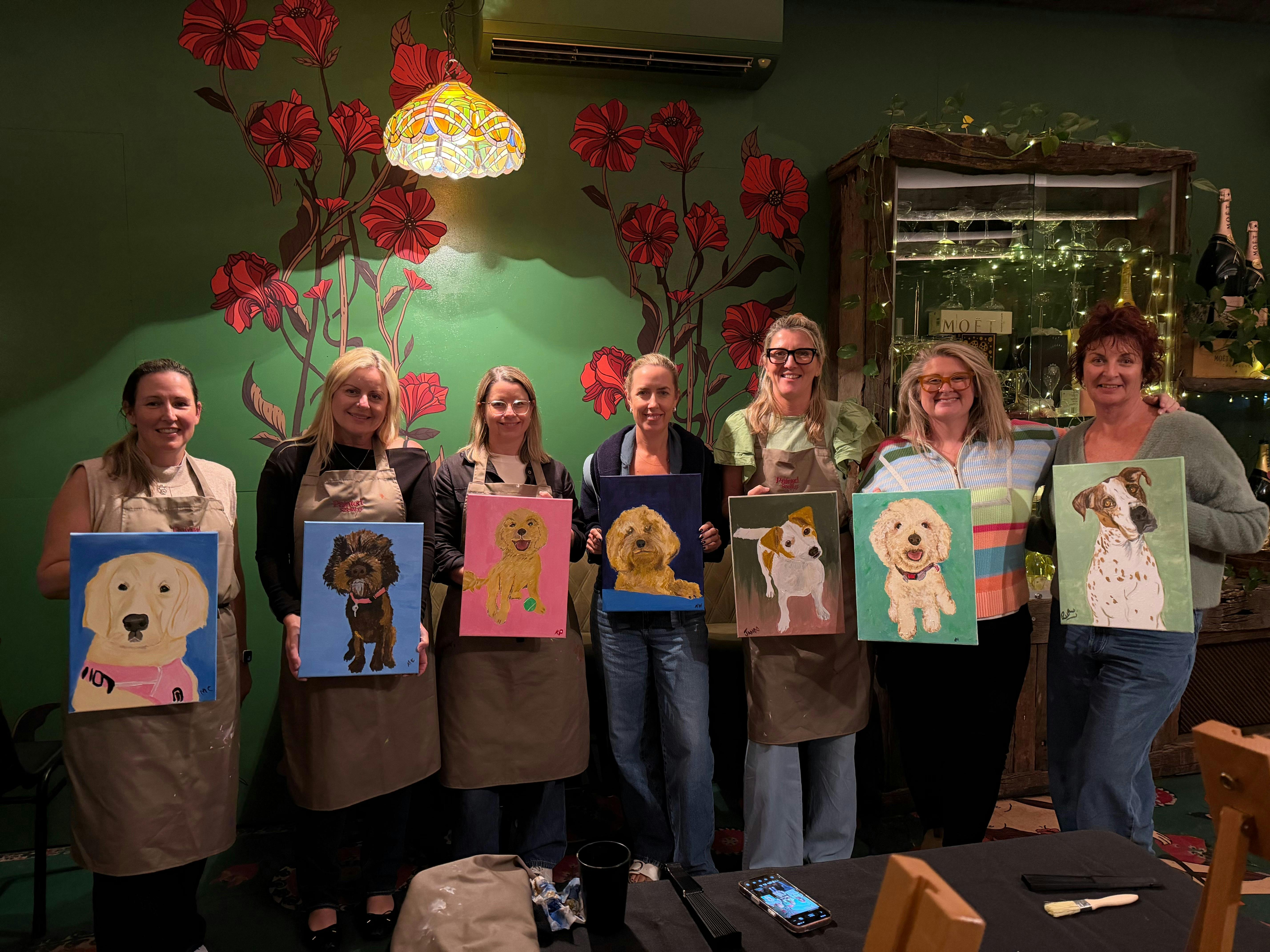 photo of women with paintings of their dogs paint and sip gold coast