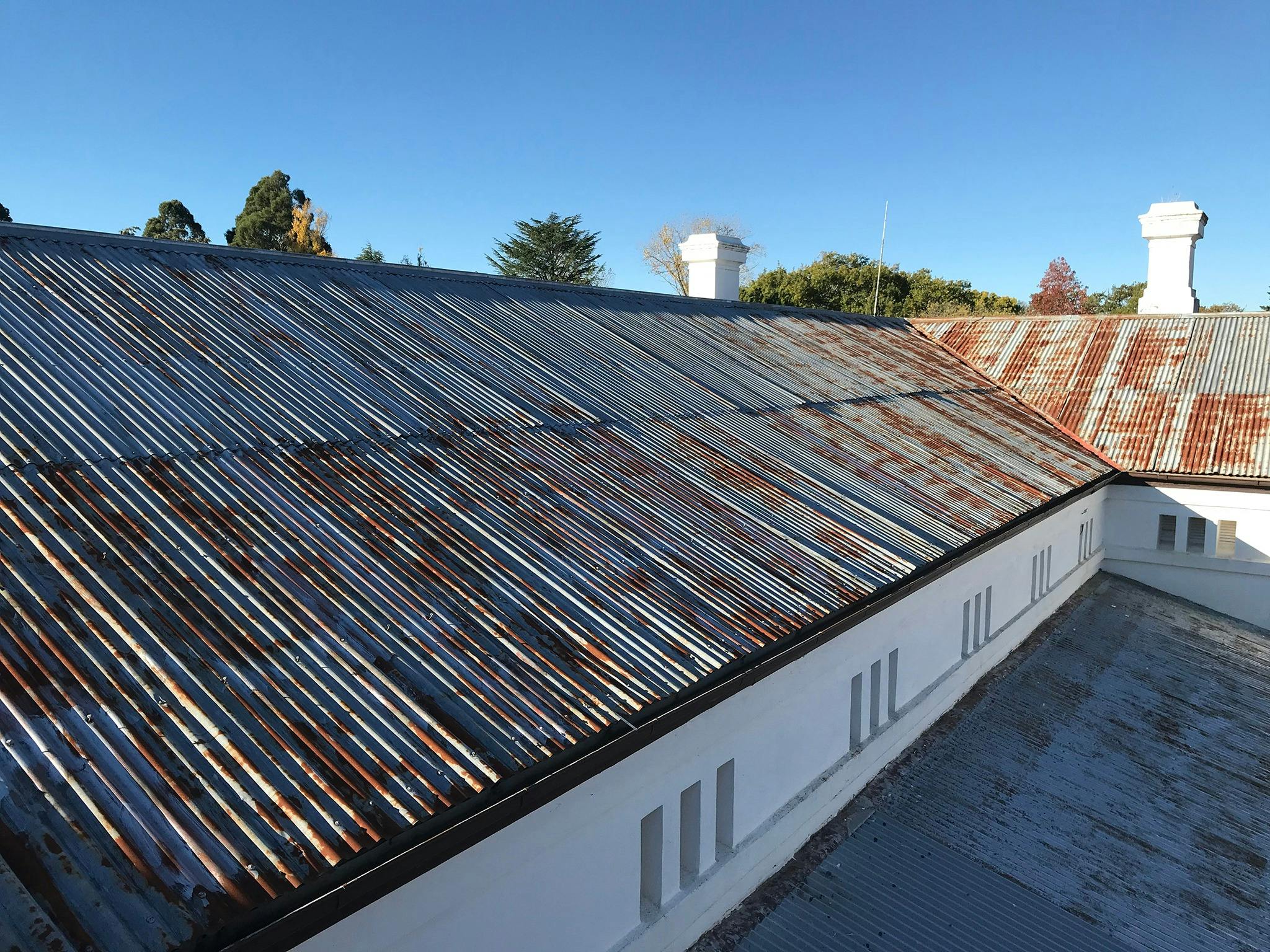Colour photo of the store galvanized steel roof-line showing some surface rust