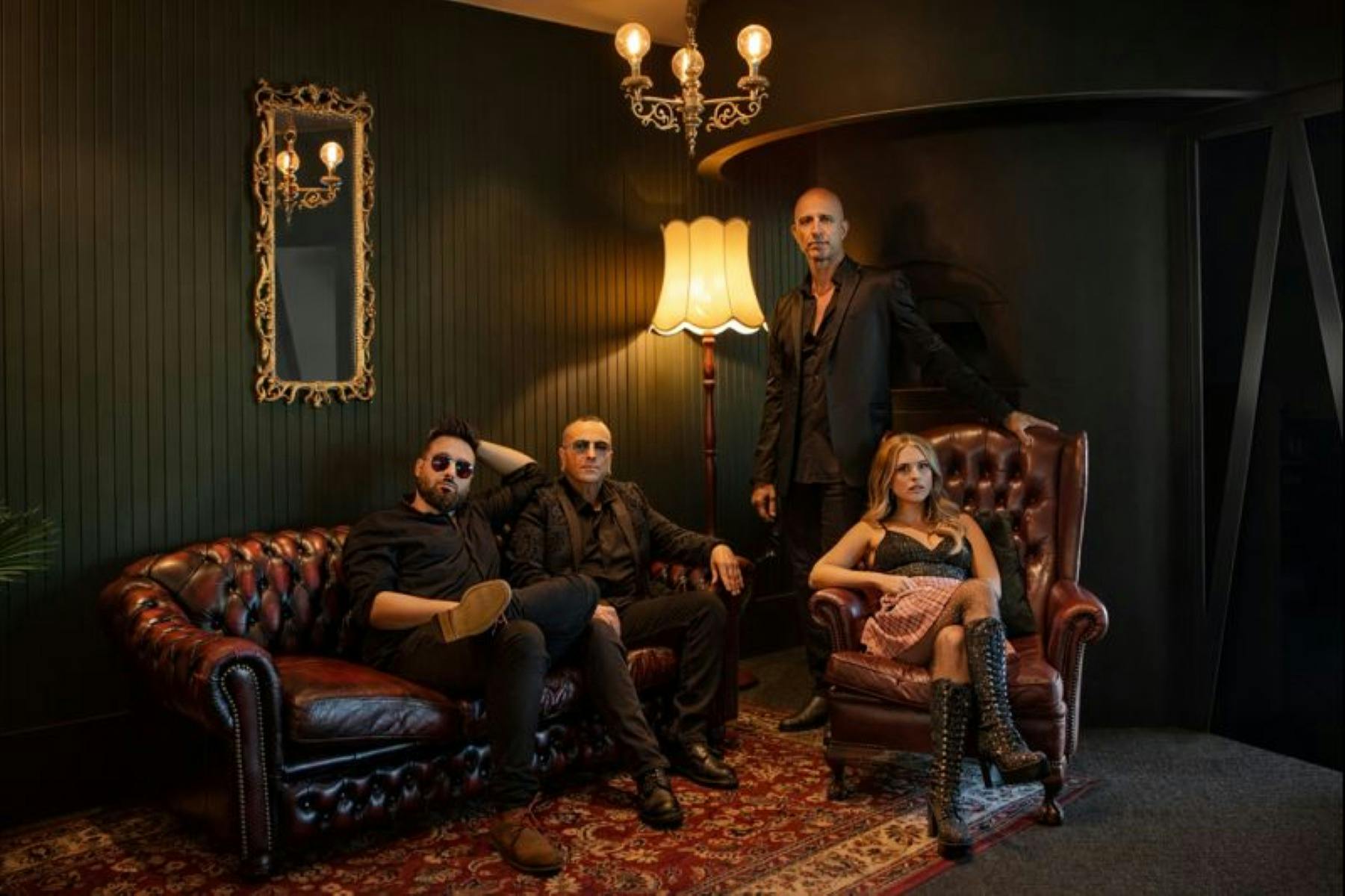 Hindley Street Country Club band posing together in green room setting.