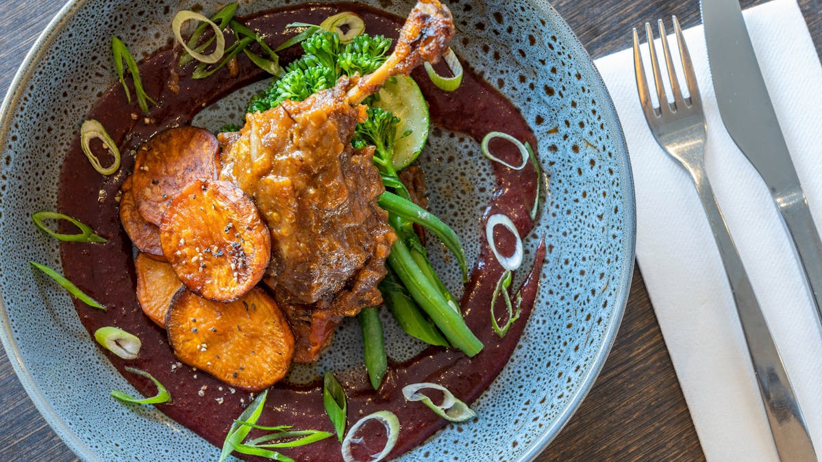 Slow cooked marinated duck leg in asian light herbs and spices; accompanied with roasted sweet