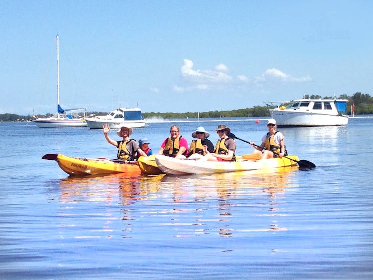 family kayaking on the river