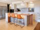 25 walkers lane kitchen with an island table and bar stools, refrigerator