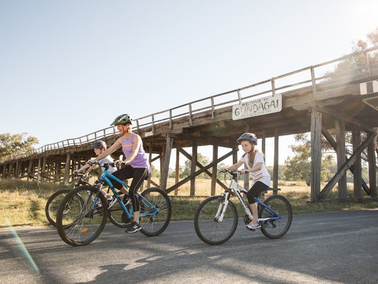 Bike riders under the bridge