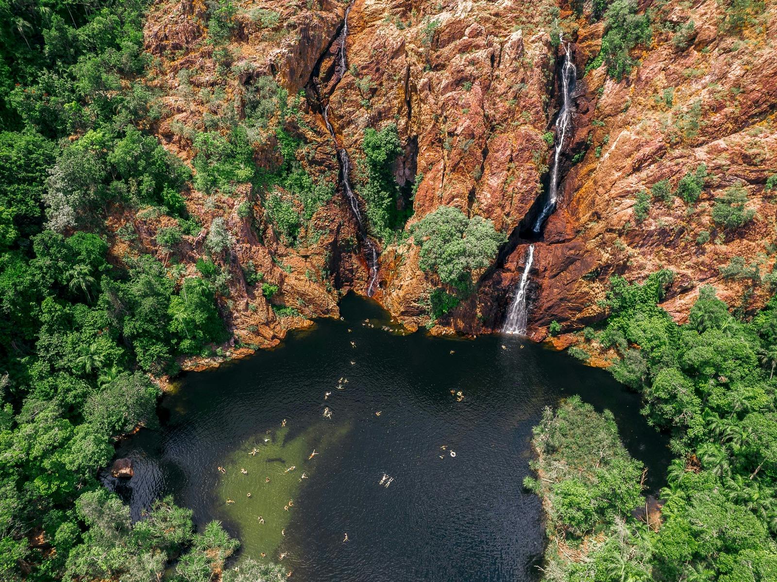 people swimming in Wangi Falls