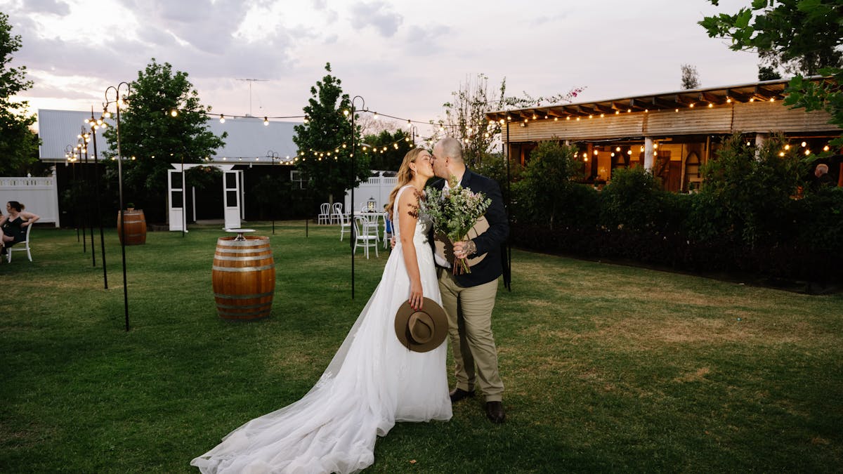 couple outside the barn bar