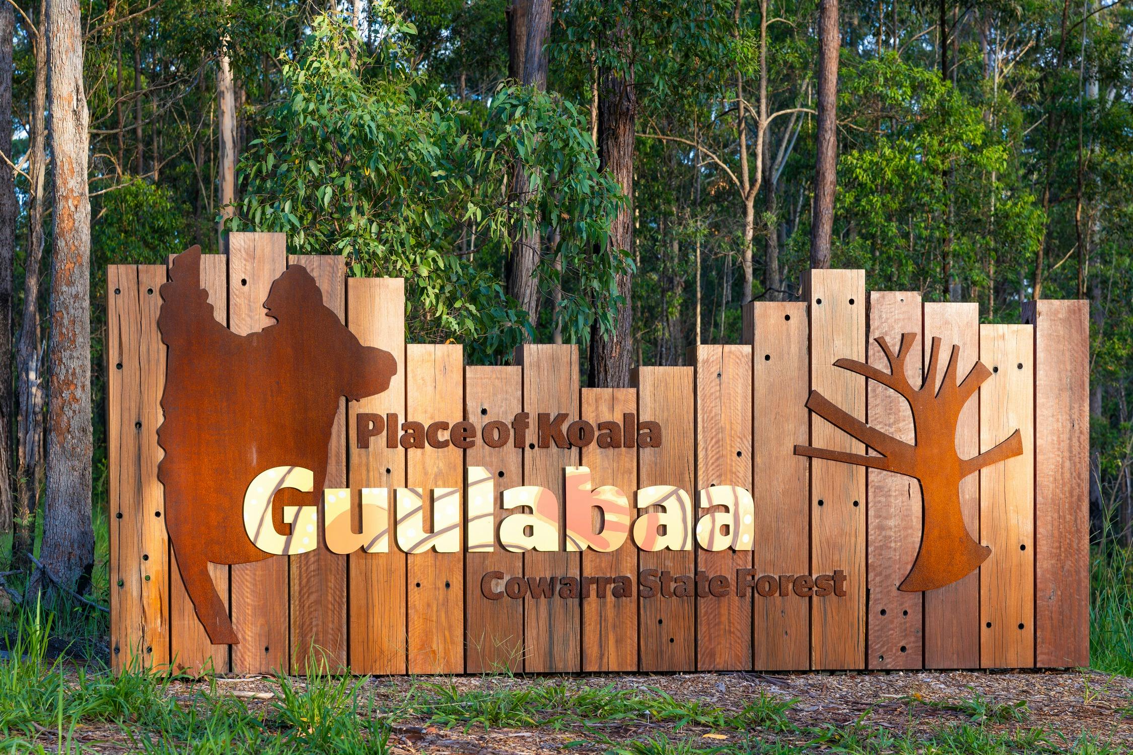 Timber and metal sign at the entrance to Guulabaa