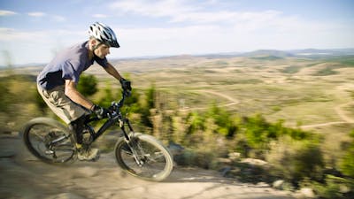 A man riding a mountain bike at Stromlo Forest Park