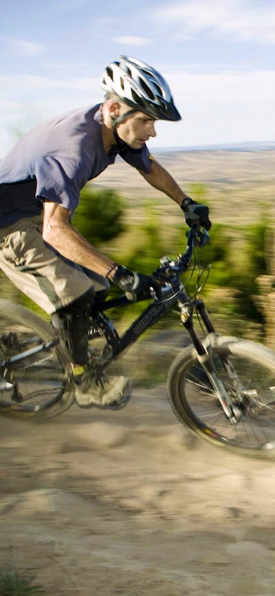 A man riding a mountain bike at Stromlo Forest Park