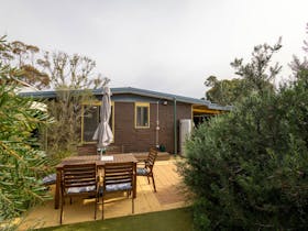 The back yard features a lusciously green native garden