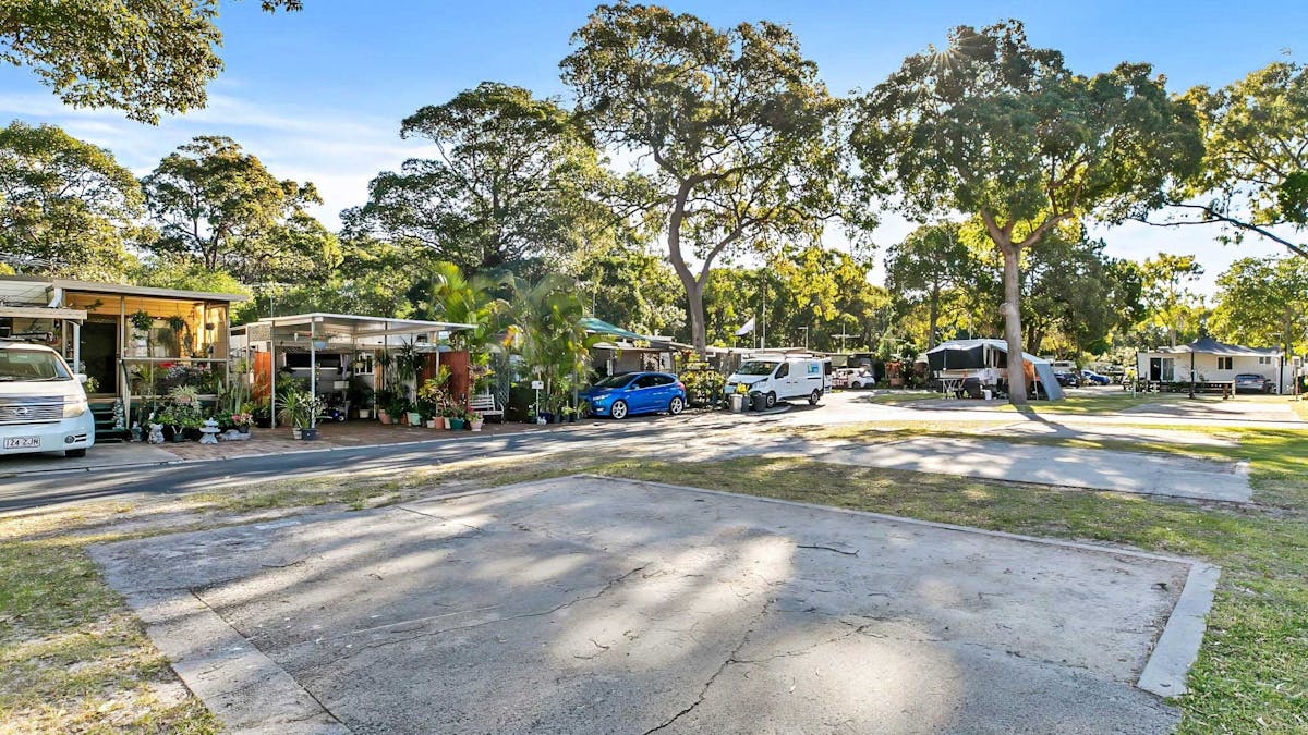 Shaded, powered caravan site at Bribie Island Holiday Park