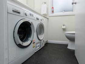 Fully equiped laundry with additional toilet.
