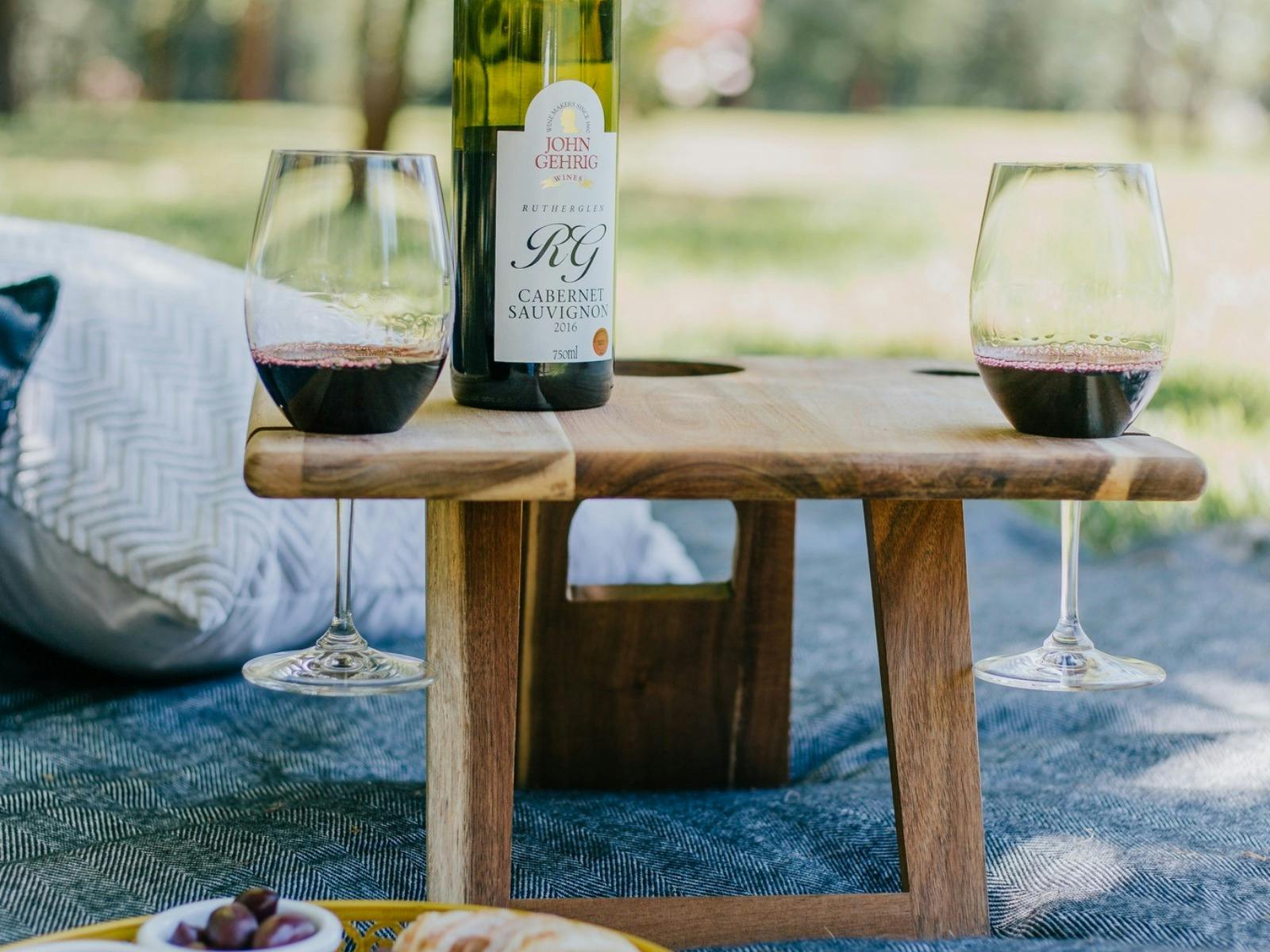 images of bottles of wine, glasses and picnic rug