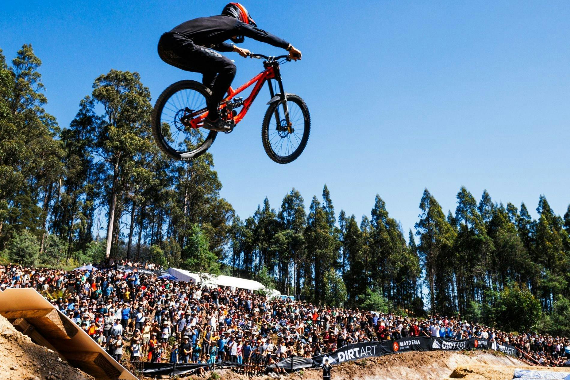 Rider jumping with big crowd