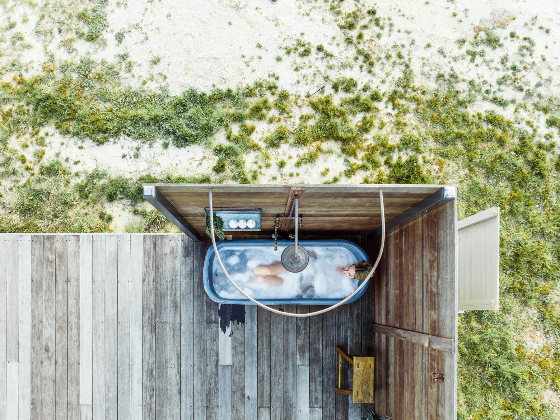 Woman soaking in an outdoor vintage bath