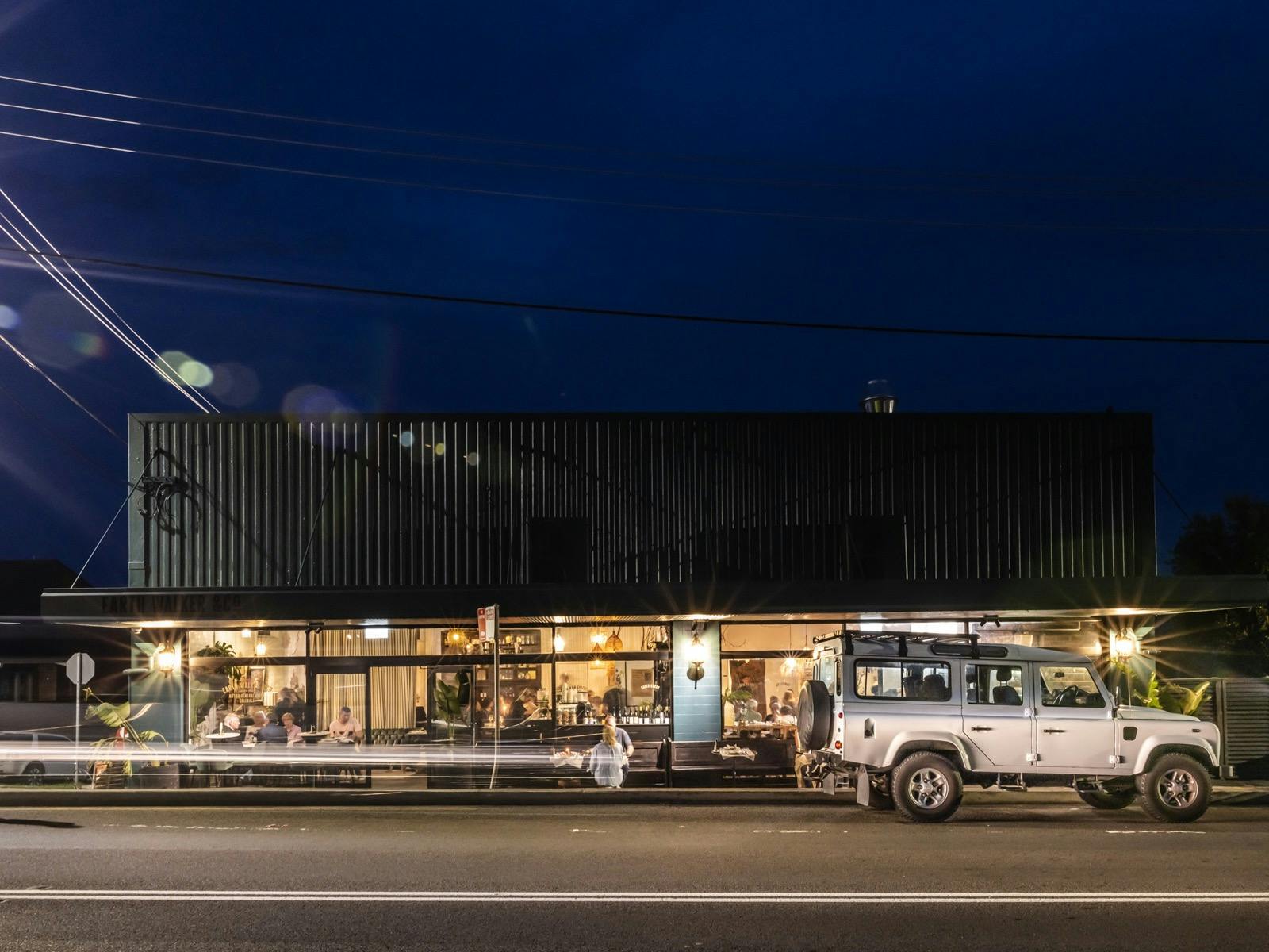 Night view of Earth Walker glowing under a deep blue sky, evoking journey and place.
