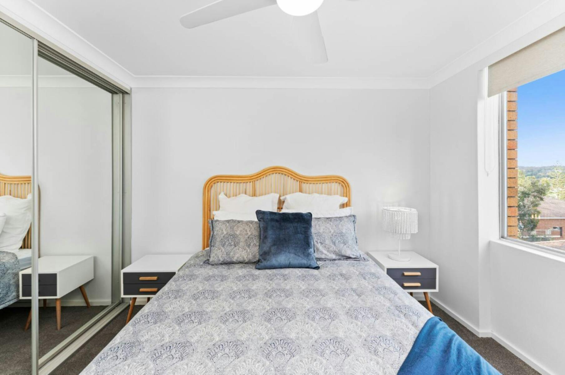 Bedroom with Queen bed, statement bed head, wardrobe and ceiling fan