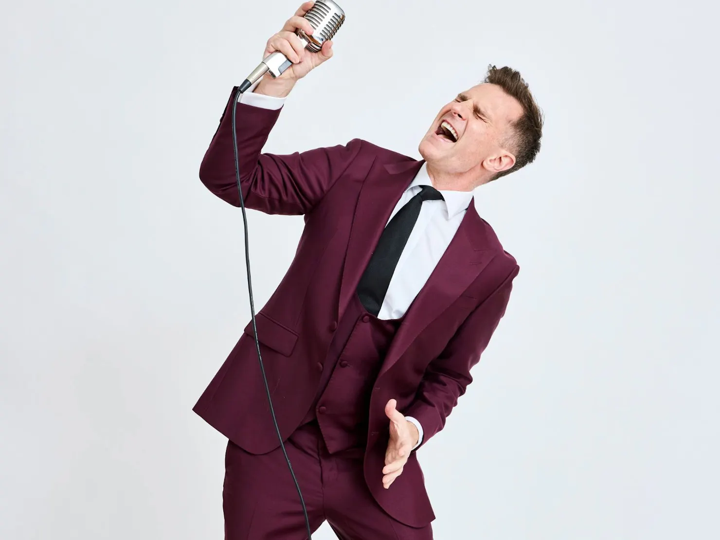 David with an old fashion microphone singing